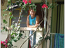 Zoe outside her tin hut and bourgonvillia panelling