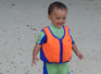 Thomas on the beach. The life vest was no more than a body warmer. He has his mothers thermostat.